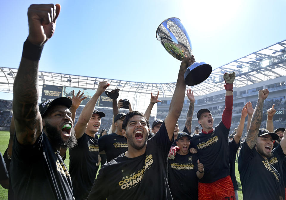 Los Angeles FC forward Carlos Vela holds up the cup after defeating Austin FC in the MLS playoff Western Conference final soccer match Sunday, Oct. 30, 2022, in Los Angeles. (AP Photo/John McCoy)
