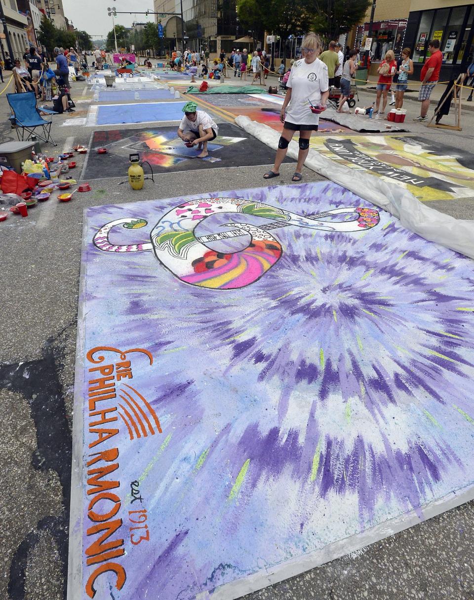 In this file photo, Artists Julie Wonner and Becky Coppock work on chalk drawings along State Street in downtown Erie during the August 2018 CelebrateErie festival