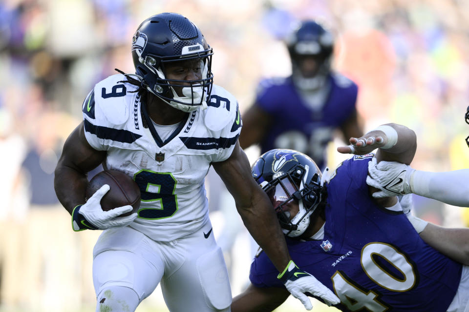 Seattle Seahawks running back Kenneth Walker III (9) runs from Baltimore Ravens linebacker Malik Harrison (40) during the second half of an NFL football game, Sunday, Nov. 5, 2023, in Baltimore. (AP Photo/Nick Wass)