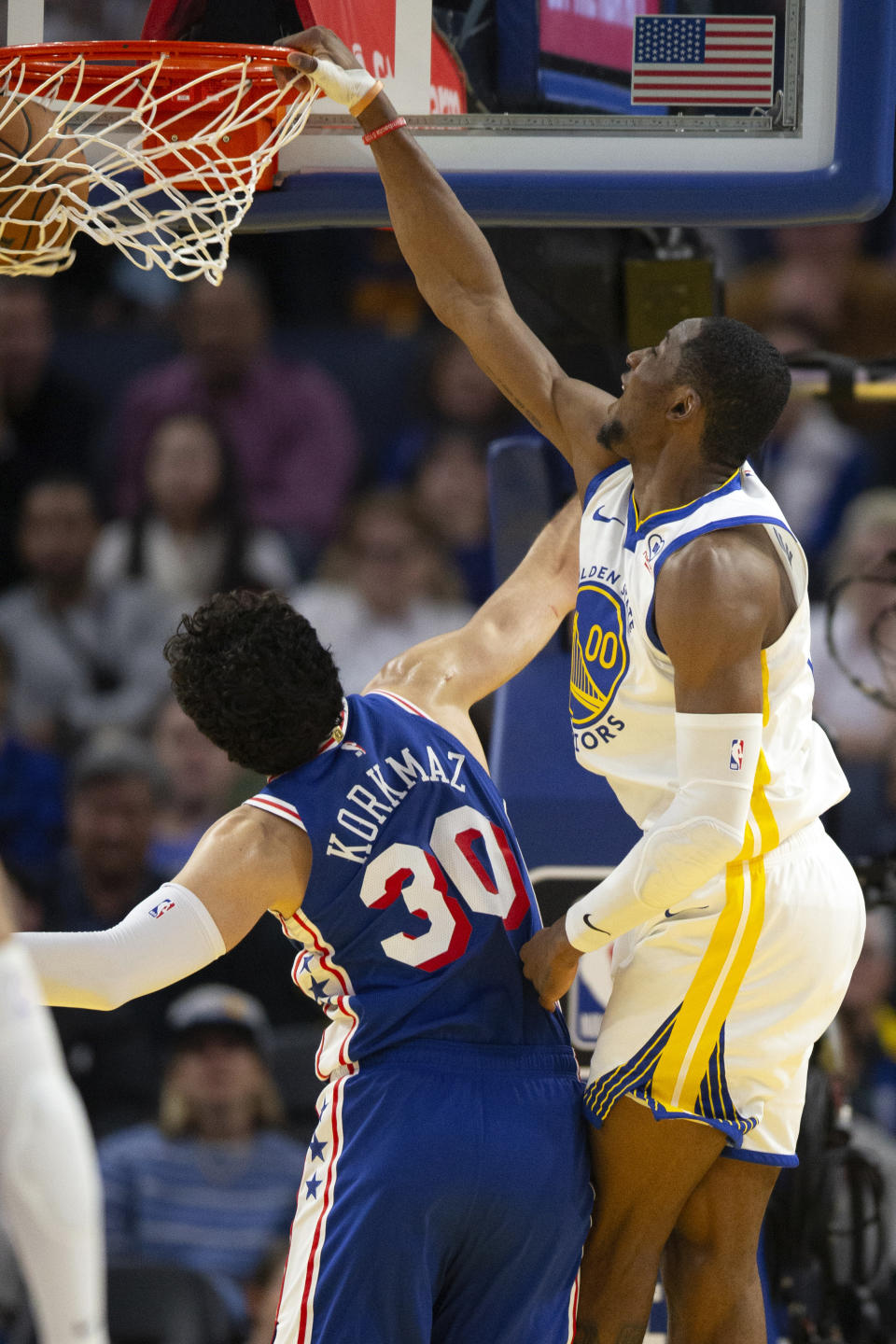 Golden State Warriors forward Jonathan Kuminga (00) dunks over Philadelphia 76ers guard Furkan Korkmaz (30) during the first half of an NBA basketball game, Tuesday, Jan. 30, 2024, in San Francisco. (AP Photo/D. Ross Cameron)