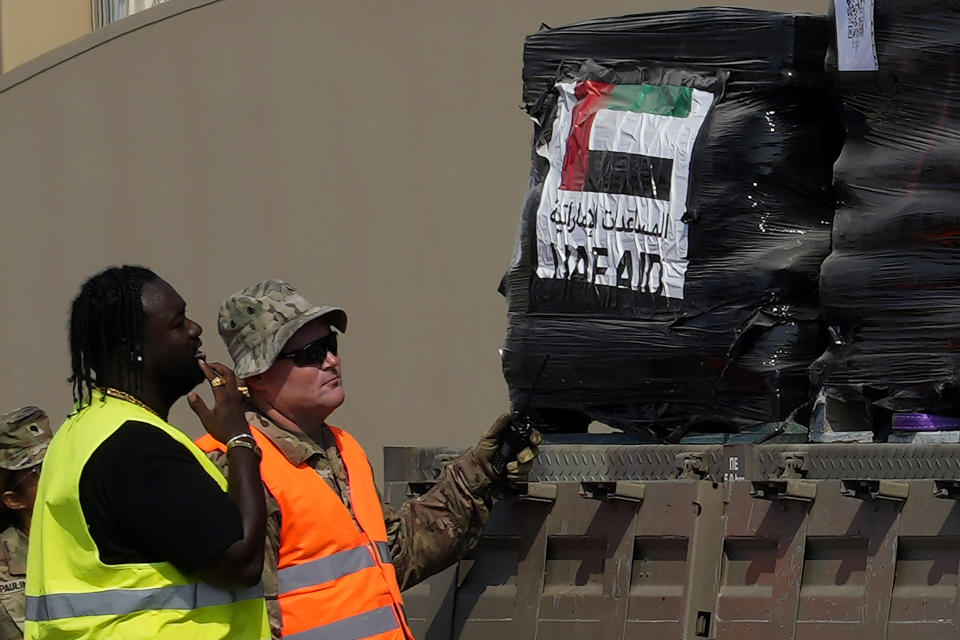 A U.S soldier, right, and staff member check a Gaza aid on a truck as it enters a U.S ship to be unloaded, at the port of Larnaca, Cyprus, Wednesday, June 26, 2024. An official with the U.S. humanitarian assistance agency USAID says thousands of tons of food, medicines and other aid piled up on a Gaza beach isn't reaching those in need because of a dire security situation on the ground where truck drivers are either getting caught in the crossfire or have their cargo seized by "gang-like" groups. (AP Photo/Petros Karadjias)