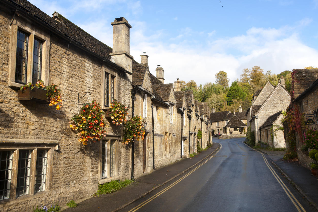 A row of attractive stone cottages in Castle Combe, Wiltshire, England, UK claimed to be Englands prettiest village. (Photo By: Geography Photos/Universal Images Group via Getty Images)