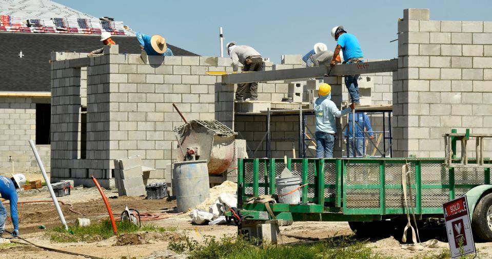 A construction crew works at the Pangea Park development in Viera, where "flex options" for the homes include in-law suites, game rooms and wine niches.