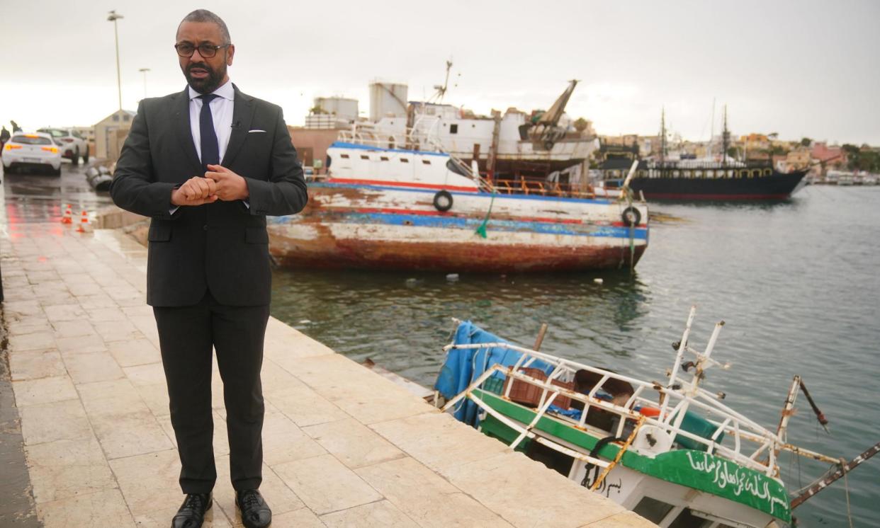 <span>James Cleverly walks past a sunken small boat during a visit to Lampedusa port.</span><span>Photograph: Victoria Jones/PA</span>