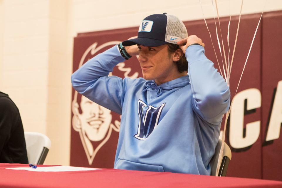 Caravel Academy's Ethan Potter puts on a Villanova hat after committing to the school to play football during a signing day ceremony at Caravel Academy in 2019.