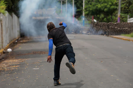 A demonstrator throws a homemade device during the funeral service of Jose Esteban Sevilla Medina, who died during clashes with pro-government supporters in Monimbo, Nicaragua July 16, 2018.REUTERS/Oswaldo Rivas