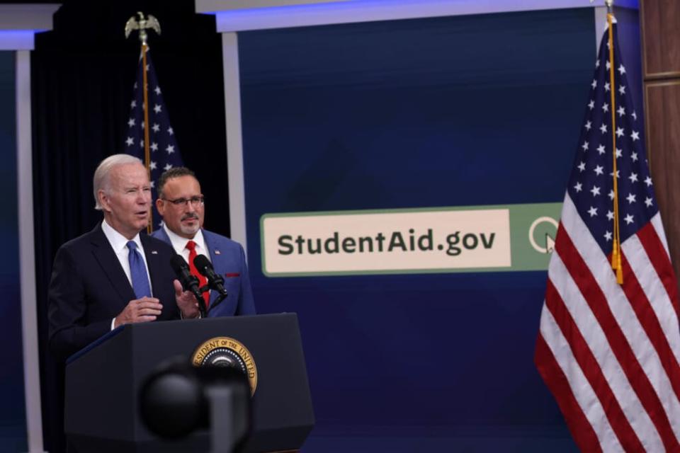 U.S. President Joe Biden speaks on the student debt relief plan as Secretary of Education Miguel Cardona (R) listens in the South Court Auditorium at the Eisenhower Executive Office Building on October 17, 2022 in Washington, DC. President Biden gave an update on the student debt relief portal beta test. (Photo by Alex Wong/Getty Images)