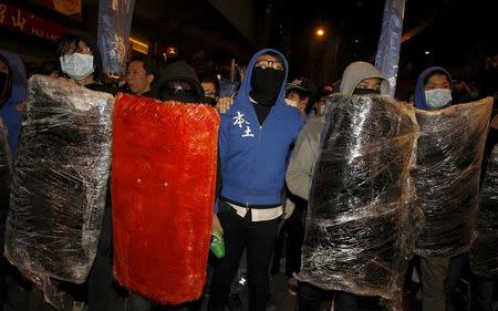 Protesters supporting illegal hawkers carry makeshift shields at Hong Kong's Mongkok shopping district, China early February 9, 2016. REUTERS/Liau Chung-ren