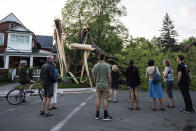 <p>Community members gather to look at a tree that was destroyed during a major storm in Ottawa on Saturday, May 21, 2022. (Photo by Justin Tang/The Canadian Press)</p> 