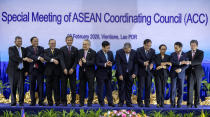 Foreign ministers of The Association of Southeast Asian Nations (ASEAN) from left, Malaysia's Foreign Minister Saifuddin Abdullah, Myanmar's Minister of State for Foreign Affaires Kyaw Tin, Philippines' Foreign Affaires Secretary Teodoro Locsin Jr., Singapore's Foreign Minister Vivian Balakrishnan, Thailand's Foreign Minister Don Pramudwinai, Vietnam's Deputy Prime Minister and Foreign Minister Phạm Binh Minh, Brunei's Second Minister of Foreign Affairs and Trade Erywan Yusof, Cambodia's Foreign Minister Prak Sokhon, Indonesia's Foreign Minister Retno Marsudi, Laos' Foreign Minister Saleumxay Kommasith, and ASEAN Secretary General Dato Lim Jock Hoi applaud after posing for a group photo ahead of the Special Meeting of the ASEAN coordination council in Vientiane, Laos, Thursday, Feb. 20, 2020. (AP Photo/Sakchai Lalit)