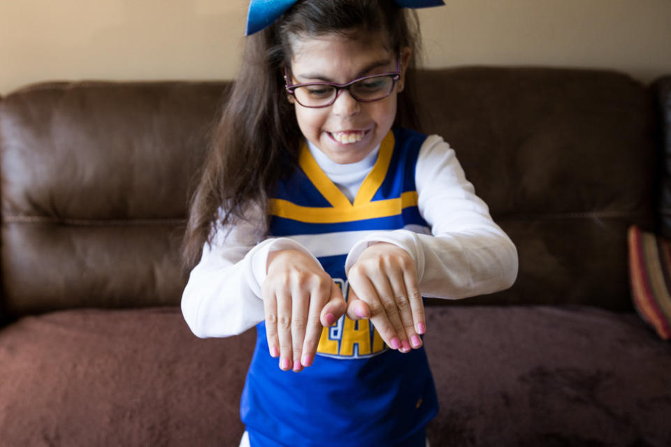 Gianna was diagnosed with <a href="https://ghr.nlm.nih.gov/condition/22q112-deletion-syndrome" target="_blank">22q11.2 deletion syndrome</a>&nbsp;in utero. Although she has had 26 surgeries, she&nbsp;is still able to participate in her town's general cheering squad. (Photo: <a href="http://karenhaberberg.com/" target="_blank">Karen Haberberg</a>)