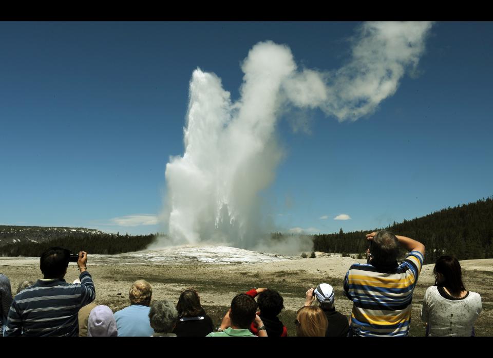 Tourists watch the 'Old Faithful' geyser which erupts on average every 90 minutes in the Yellowstone National Park, Wyoming on June 1, 2011.  (Mark Ralston, AFP / Getty Images)