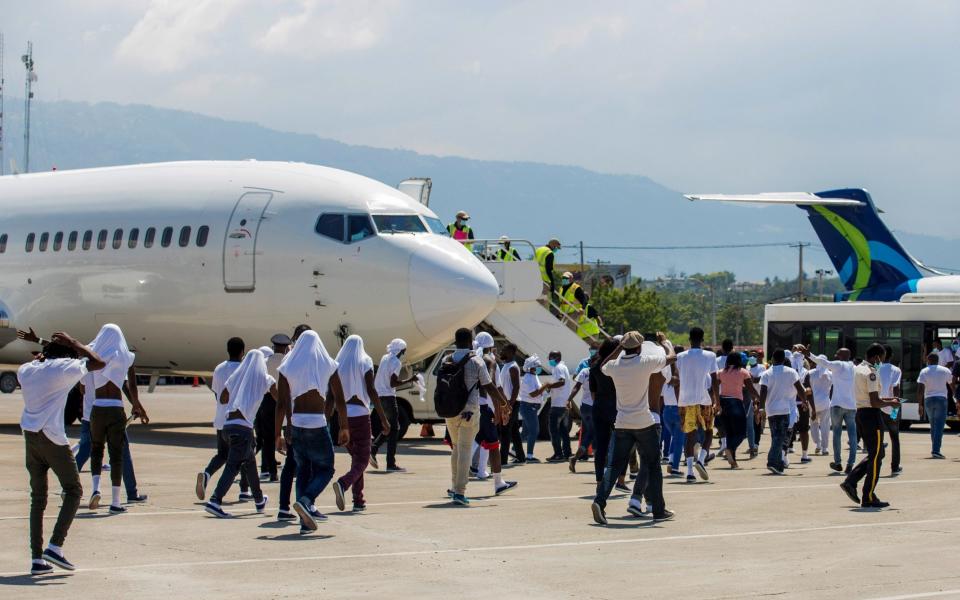 Some migrants threw their shoes at the jet in angry scenes at Haiti's main airport - REUTERS/Ralph Tedy Erol/REUTERS/Ralph Tedy Erol