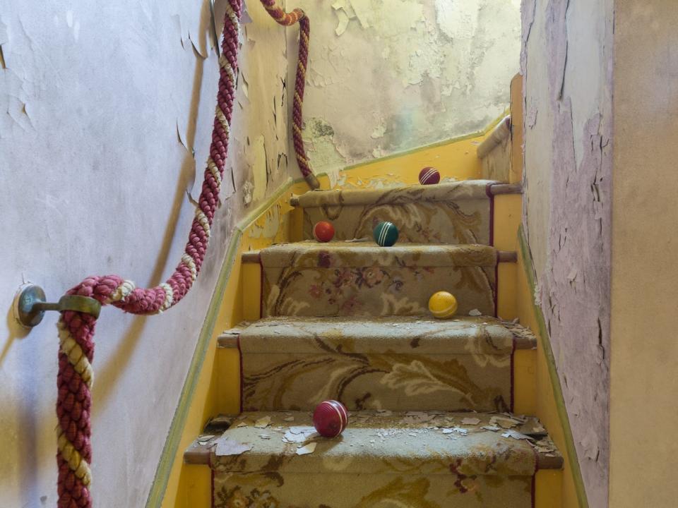 A stairwell of an abandoned circus-themed house in the Catskills, New York.