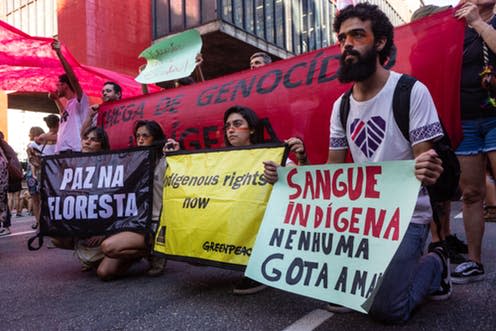 <span class="caption">Environmentalists and activists with posters "peace in the forest and an end to indigenous genocide" in protest of the rights of indigenous people, in São Paulo, Brazil, January, 2019.</span> <span class="attribution"><a class="link " href="https://www.shutterstock.com/image-photo/paulo-sp-brazil-january-01-2019-1436864681?src=VCCrIheudX3up9gE9o6g4w-1-0" rel="nofollow noopener" target="_blank" data-ylk="slk:PARALAXIS /Shutterstock;elm:context_link;itc:0;sec:content-canvas">PARALAXIS /Shutterstock</a></span>