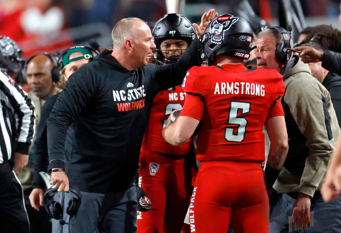 N.C. State head coach Dave Doeren congratulates quarterback Brennan Armstrong (5) after a long run during the second half of N.C. State’s 20-6 victory over Miami at Carter-Finley Stadium in Raleigh, N.C., Saturday, Nov. 4, 2023. Ethan Hyman/ehyman@newsobserver.com
