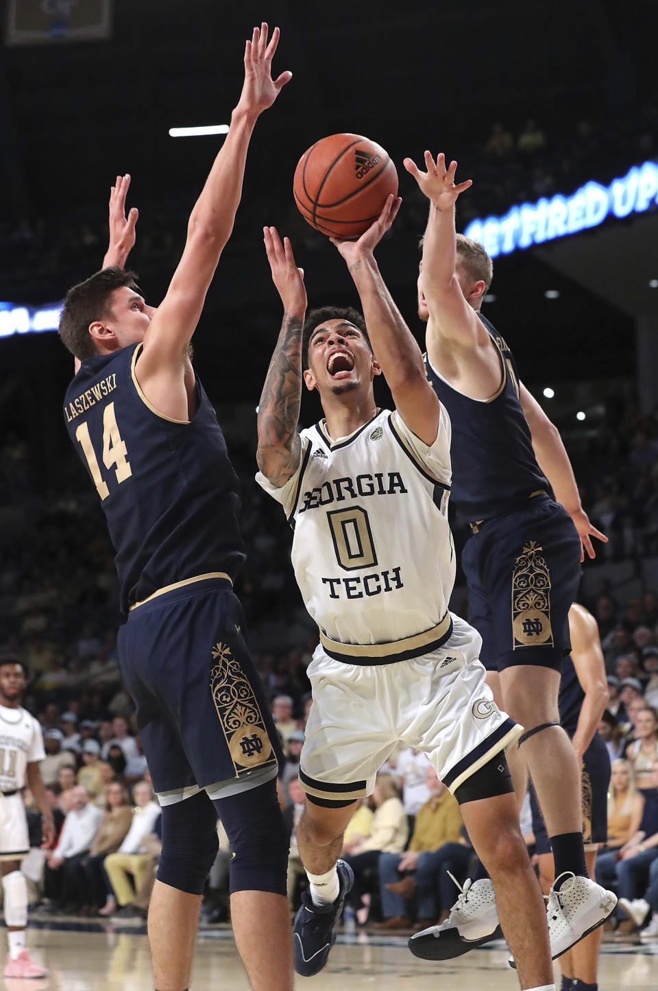 Georgia Tech guard Michael Devoe is double-teamed by Notre Dame defenders Nate Laszewski, left, and Rex Pflueger during the first half of an NCAA college basketball game Wednesday, Jan. 15, 2020, in Atlanta. (Curtis Compton/Atlanta Journal-Constitution via AP)