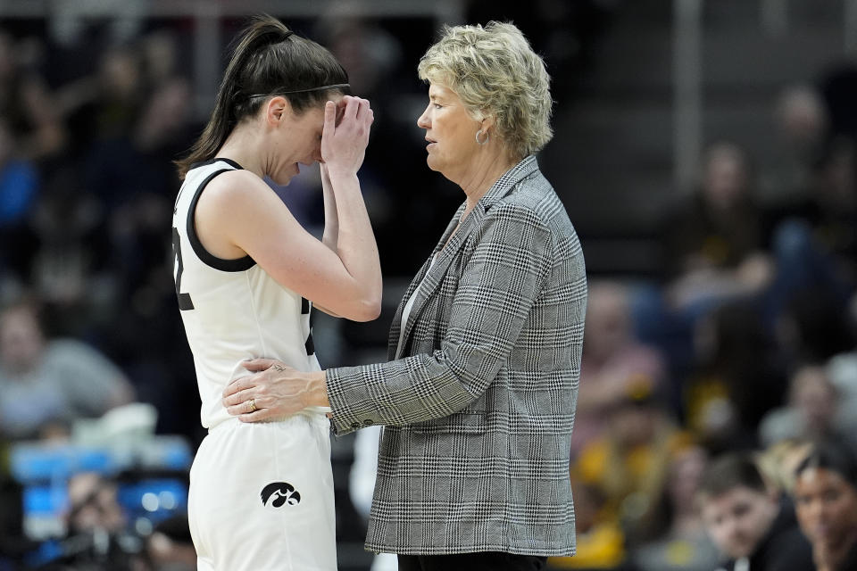 Iowa guard Caitlin Clark (22) talks with head coach Lisa Bluder during the fourth quarter of a Sweet Sixteen round college basketball game against Colorado during the NCAA Tournament, Saturday, March 30, 2024, in Albany, N.Y. (AP Photo/Mary Altaffer)