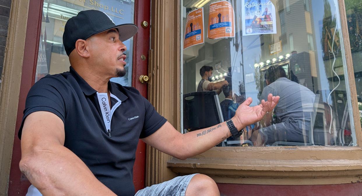 Larry Rowe was sitting on the stoop of his barber shop on West King Street in Lancaster on Aug. 26, 2024. He is torn about the election. He’s unsure about Harris and believes that Trump would be better for the economy, but he has reservations about the former president.