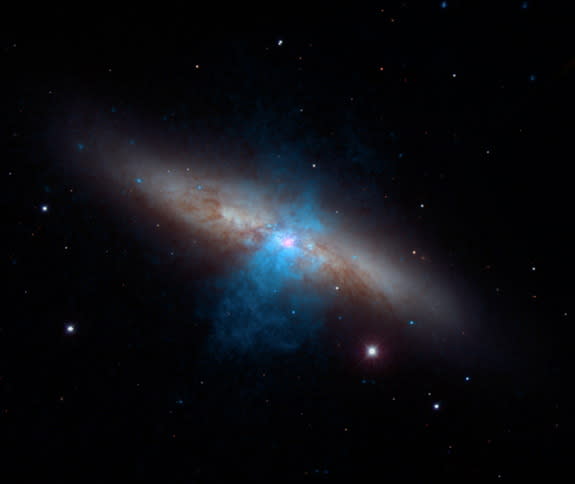 A unique, powerful pulsar (pink) sits at the center of the galaxy Messier 82 as shown in this new multi-wavelength image. NASA's NuSTAR mission made the using its high-energy X-ray vision. Image released Oct. 8, 2014.