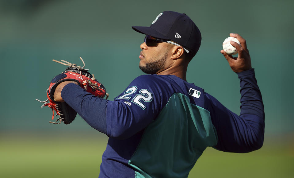 Seattle Mariners' Robinson Cano throws during batting practice prior to a baseball game against the Oakland Athletics Tuesday, Aug. 14, 2018, in Oakland, Calif. Cano is returning after an 80-game drug suspension. The All-Star second baseman last played May 15. (AP Photo/Ben Margot)