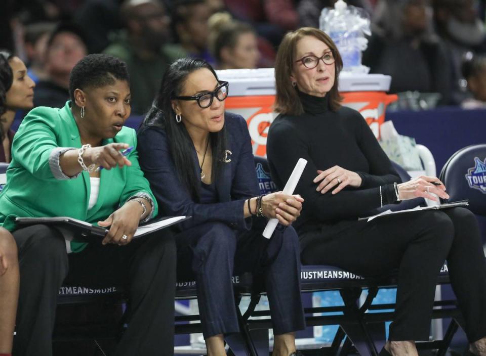 Coach Dawn Staley, center, Jolette Law, left, and Lisa Boyer confer during the second half of action against Arkansas in the SEC Tournament at Bon Secours Wellness Arena in Greenville. 3/8/19