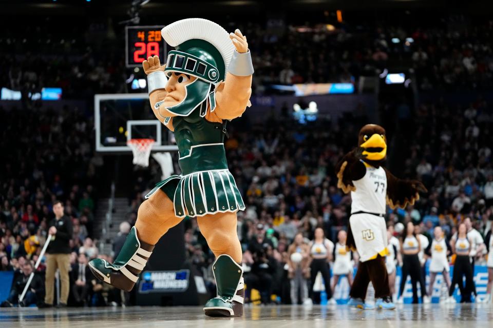 In March 2023 in Columbus, Ohio, Sparty and Iggy, mascots for the Michigan State Spartans and the Marquette Golden Eagles, compete in a dance-off during the second round of the NCAA men’s basketball tournament at Nationwide Arena.