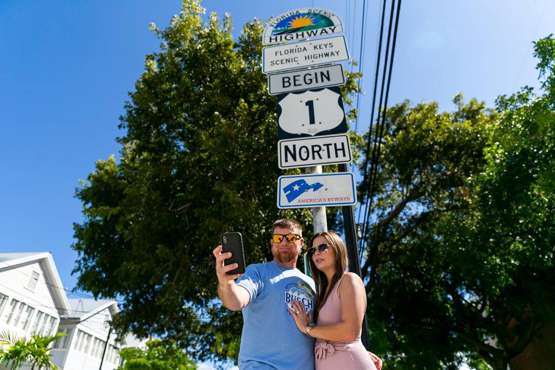 Jamie Roberts and wife, Nicole Roberts, pose for a selfie at the Overseas Highway mile marker 0 in Key West, Florida on Tuesday, October 12, 2021.