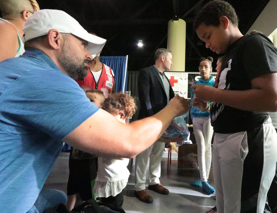 Congressional candidate Cory Mills, at left. and Congressman Michael Waltz visit with a family at the American Red Cross shelter in the Ocean Center in Daytona Beach on Wednesday October 5, 2022. Mills is running in the 7th District, covering Seminole and southern Volusia counties, while Waltz is seeking reelection in the 6th, including north Volusia and other counties to the north and west.