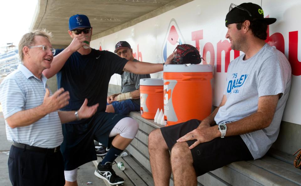 Pensacola Blue Wahoos owner Quint Studer, left, talks with two-time Masters golf champion Bubba Watson, right, before the Bagdad native takes batting practice with the team.