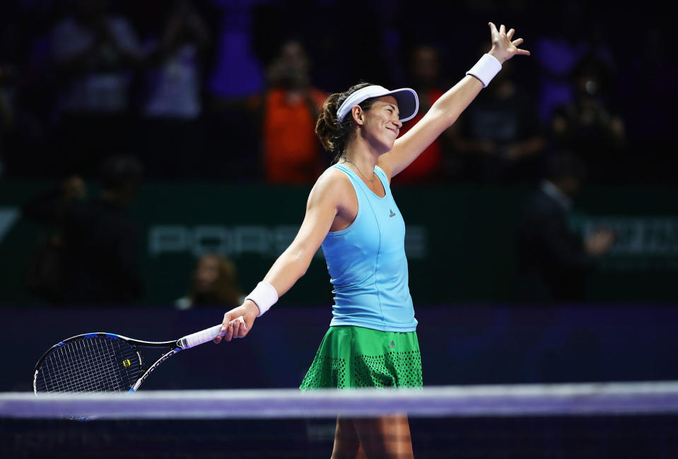 Garbine Muguruza celebrates her tennis match victory in Singapore