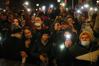 People shine the lights of their mobile phones during the opposition rally in support of jailed opposition leader Alexei Navalny in Moscow, Russia, Wednesday, April 21, 2021. Police across Russia have arrested more than 180 people in connection with demonstrations in support of imprisoned opposition leader Alexei Navalny, according to a human rights group. (AP Photo/Alexander Zemlianichenko)