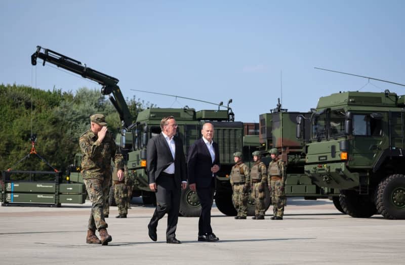 German Chancellor Olaf Scholz (R), Boris Pistorius (C), German Minister of Defense, and Ingo Gerhartz (L), Inspector of the German Air Force, take part in the ceremonial commissioning of the IRIS- T SLM air defence system at the Todendorf barracks. The new air defense system is being introduced into the Bundeswehr at the air defense missile group 61. Christian Charisius/dpa