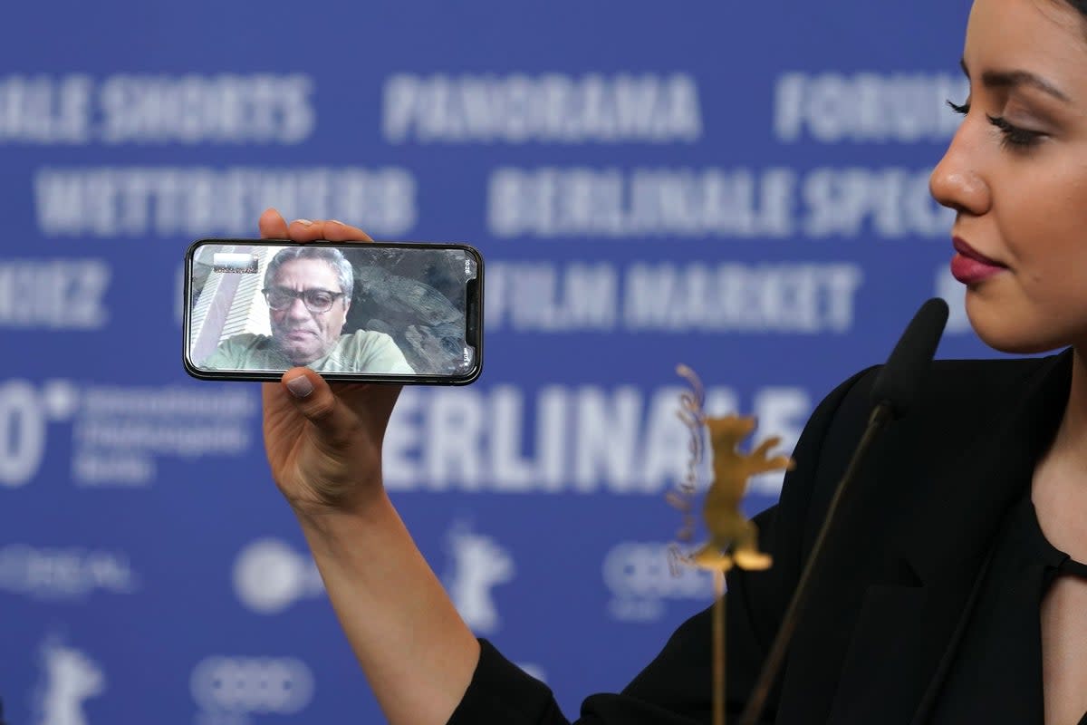 Baran Rasoulof phones Iranian director Mohammad Rasoulof, winner of the Golden Bear for Best Film for the film “There Is No Evil” at the award winners press conference during the 70th Berlinale International Film Festival Berlin (Getty Images)