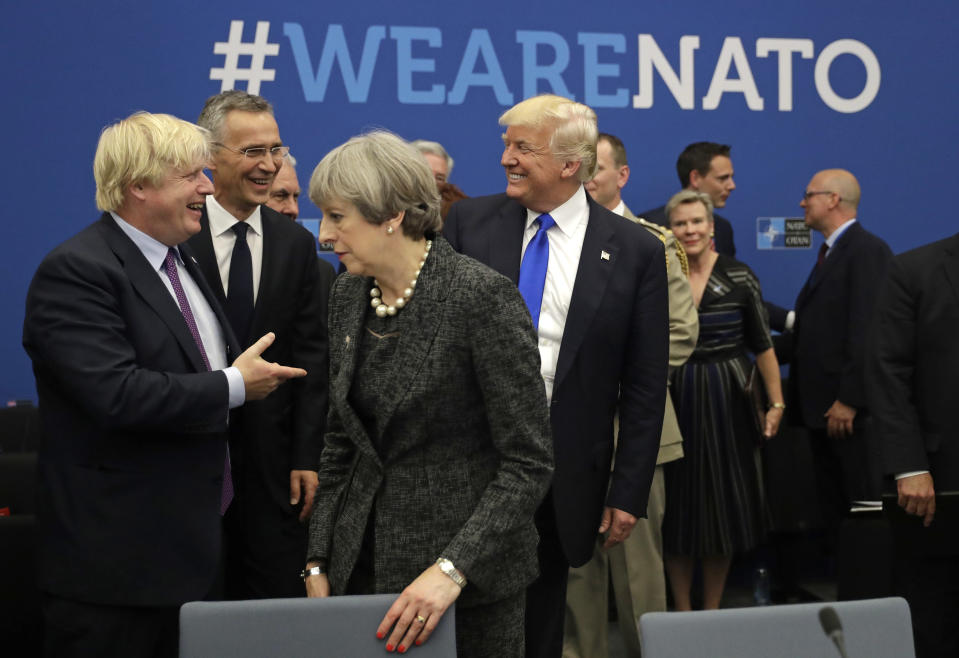 FILE - In this Thursday, May 25, 2017 file photo U.S. President Donald Trump jokes with British Foreign Minister Boris Johnson as British Prime Minister Theresa May walks past during a working dinner meeting at the NATO headquarters during a NATO summit of heads of state and government in Brussels. (AP Photo/Matt Dunham, Pool, File)