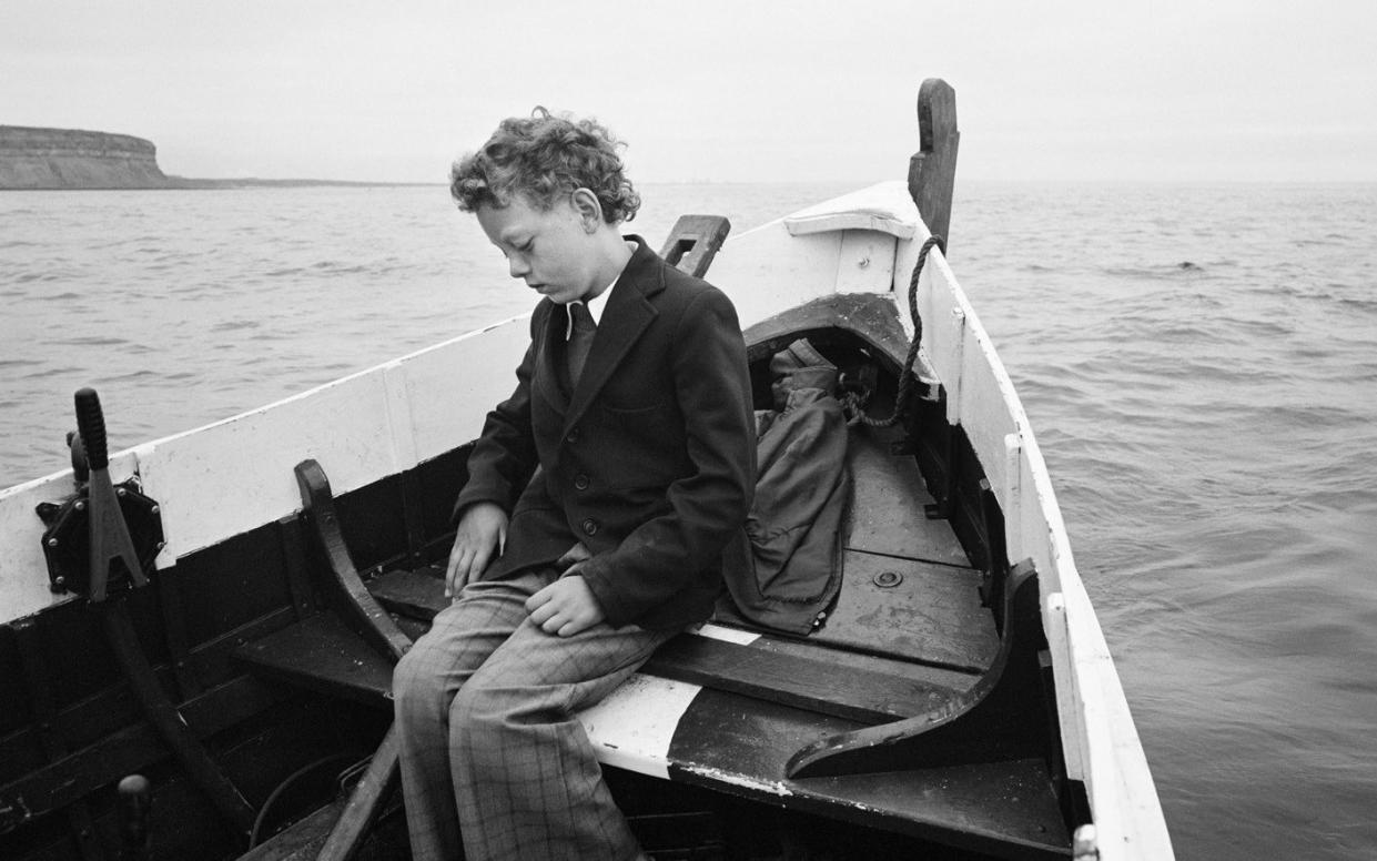 Alone on a wide, wide sea: Simon being taken to sea for the first time since his father drowned, Skinningrove, North Yorkshire, 1983 - Chris Killip