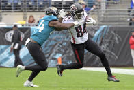 Atlanta Falcons running back Cordarrelle Patterson, right, tries to get past Jacksonville Jaguars linebacker Myles Jack (44) during the first half of an NFL football game, Sunday, Nov. 28, 2021, in Jacksonville, Fla. (AP Photo/Phelan M. Ebenhack)