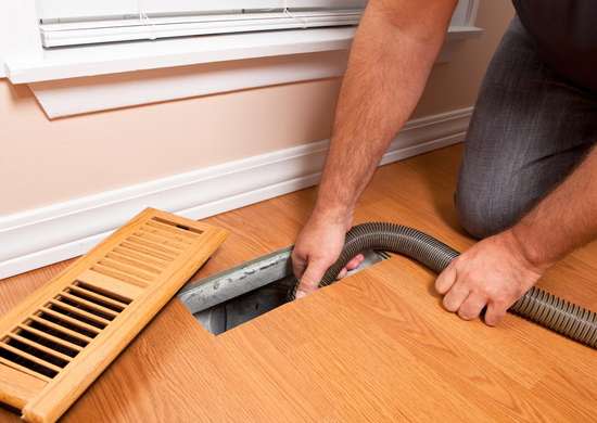 Cleaning heating vents with a vacuum attachment