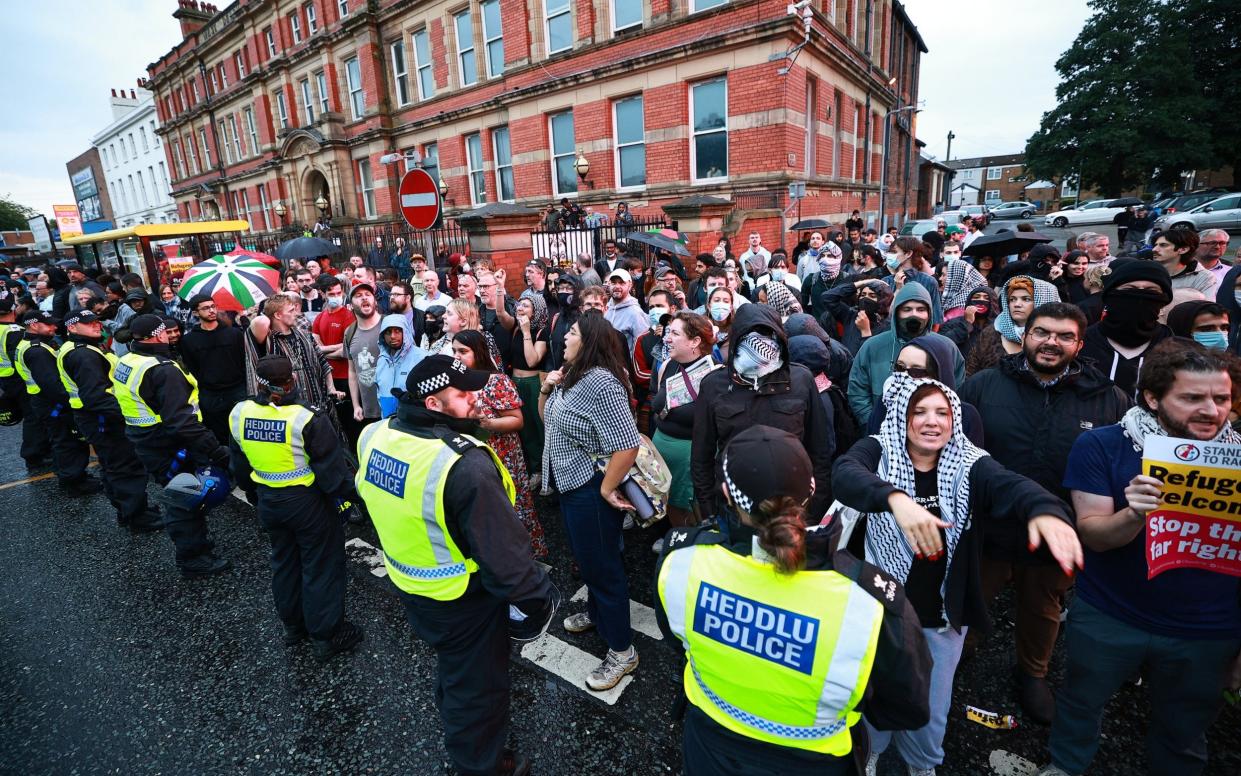 People, including anti fascists, crowd outside the Sheikh Abdullah Quilliam Mosque in Liverpool