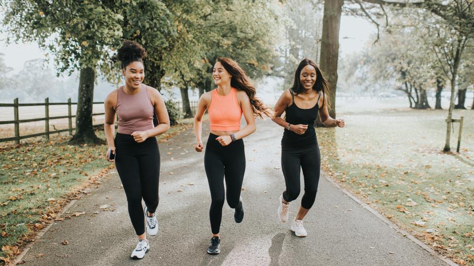 Three women running outside