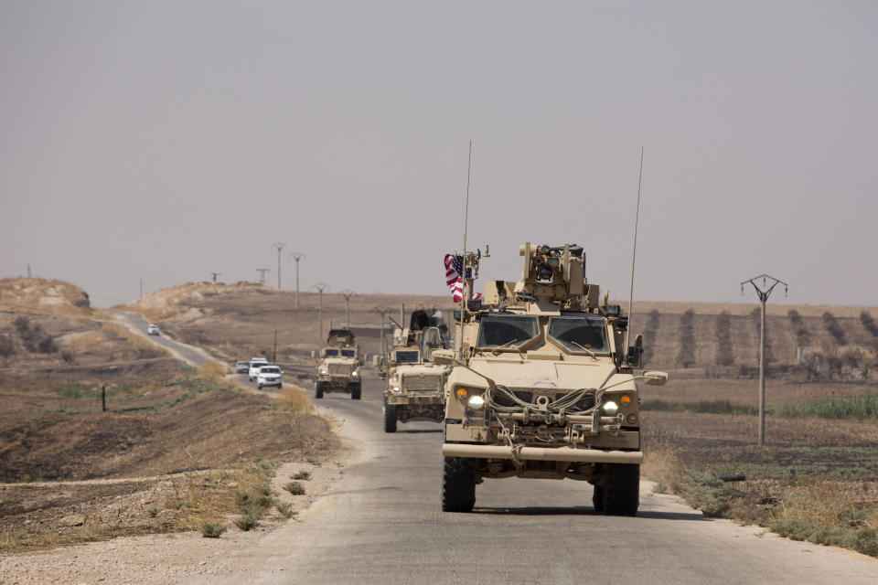 U.S. armored vehicles travel in a joint patrol of the safe zone between Syria and the Turkish border with the Tal Abyad Military Council near Tal Abyad, Syria, Friday, Sept. 6, 2019. (AP Photo/Maya Alleruzzo)