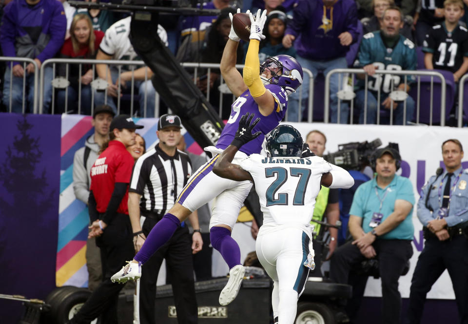 FILE - In this Sunday, Oct. 13, 2019 file photo, Minnesota Vikings wide receiver Adam Thielen, left, tries to catch a pass over Philadelphia Eagles strong safety Malcolm Jenkins (27) during the first half of an NFL football game in Minneapolis. Adam Thielen's season has been hamstrung by a hamstring injury, but the two-time Pro Bowl wide receiver remains an integral part of the offense for the Minnesota Vikings as evidenced by his diving catch in overtime to set up the playoff game win at New Orleans. (AP Photo/Bruce Kluckhohn, File)