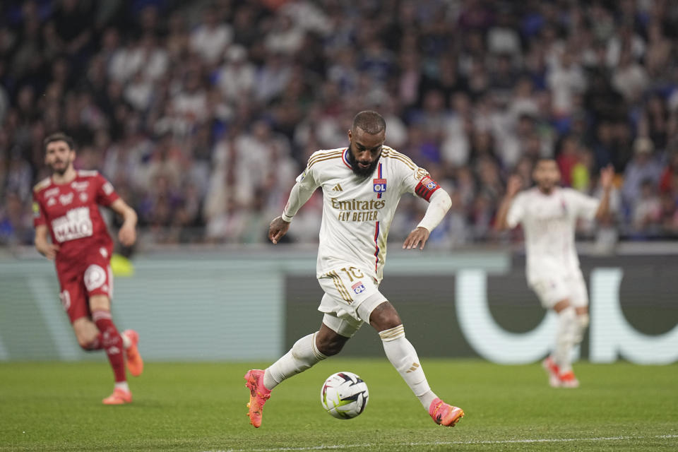 Lyon's Alexandre Lacazette tries control the ball during a French League One soccer match between Lyon and Brest at the Groupama stadium, outside Lyon, France, Sunday, April 14, 2024. (AP Photo/Laurent Cipriani)