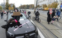 Women's rights activists hold placards during a protest in Warsaw, Poland, Wednesday, Oct. 28, 2020 against recent tightening of Poland's restrictive abortion law. Massive nationwide protests have been held ever since a top court ruled Thursday that abortions due to fetal congenital defects are unconstitutional.(AP Photo/Czarek Sokolowski)