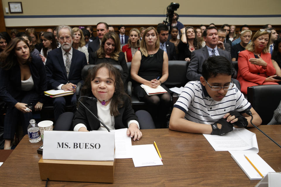 Maria Isabel Bueso, 24, of Concord, Calif., left, and Jonathan Sanchez, 16, of Boston, who both have medical deferred action, take their places at the start of a House Oversight subcommittee hearing into the Trump administration's decision to stop considering requests from immigrants seeking to remain in the country for medical treatment and other hardships, Wednesday, Sept. 11, 2019, on Capitol Hill in Washington. (AP Photo/Jacquelyn Martin)