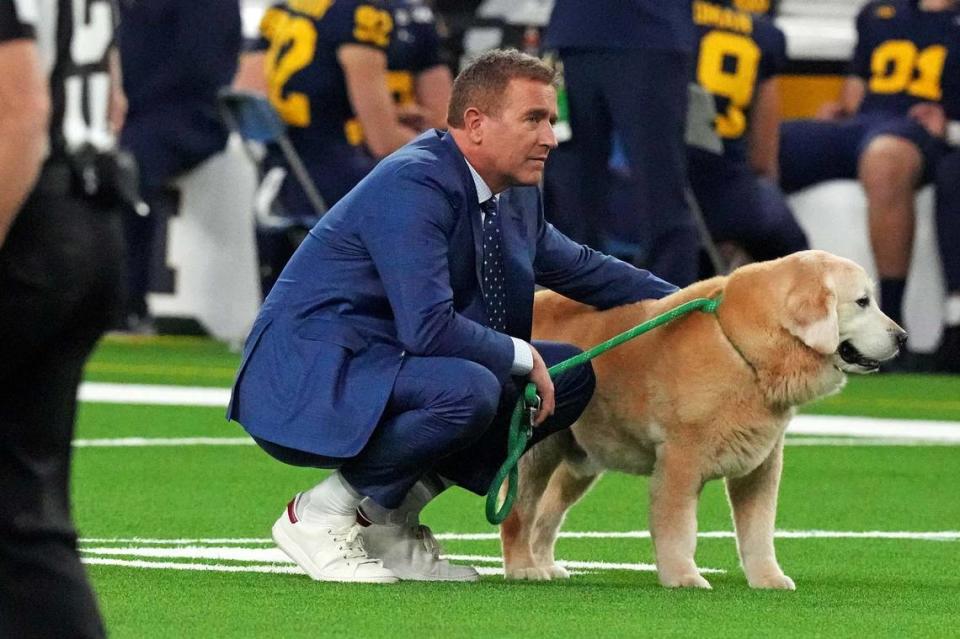 Jan 8, 2024; Houston, TX, USA; ESPN analyst Kirk Herbstreit walks his dog Ben before the 2024 College Football Playoff national championship game between the Michigan Wolverines and the Washington Huskies at NRG Stadium.