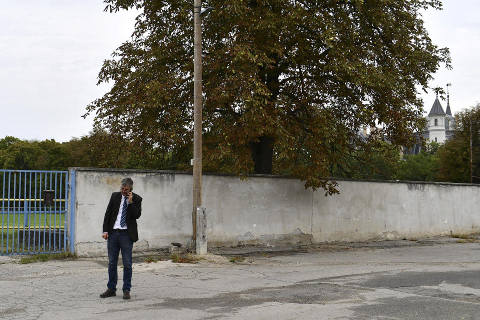 Independent lawmaker Akos Hadhazy, who has made a name for himself in Hungary as an anti-corruption crusader, is on the phone while visiting the 19th century Tura castle, owned by the son-in-law of Hungarian prime minister Viktor Orban in Tura, Hungary, Wednesday, Sept. 14, 2022. Orban is facing a reckoning with the EU, which appears set to impose financial penalties on Hungary over corruption concerns and alleged rule-of-law violations that could cost Budapest billions and cripple its already ailing economy. (AP Photo/Anna Szilagyi)