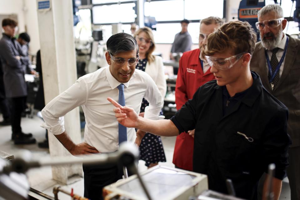 FILE - Britain's Prime Minister and Conservative Party leader Rishi Sunak speaks with students during a visit of University Technical College (UTC) in Silverstone, England, Tuesday June 11, 2024, in the build-up to the UK general election. Even in a busy year of elections, the next few days stand out. Voters go to the polls over the next week in fledgling democracies like Mauritania and Mongolia, in the Islamic Republic of Iran and in the stalwart democracies of Britain and France. (Benjamin Cremel, Pool Photo via AP, File)