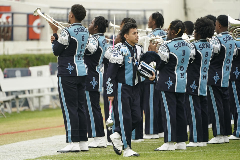 Jackson State's first Latino drum major Marvin Meda walks past the school's "Sonic Band of The South" band as they practice before an NCAA college football game between Jackson State and Southern in Jackson, Miss., Saturday, Oct. 29, 2022. (AP Photo/Rogelio V. Solis)