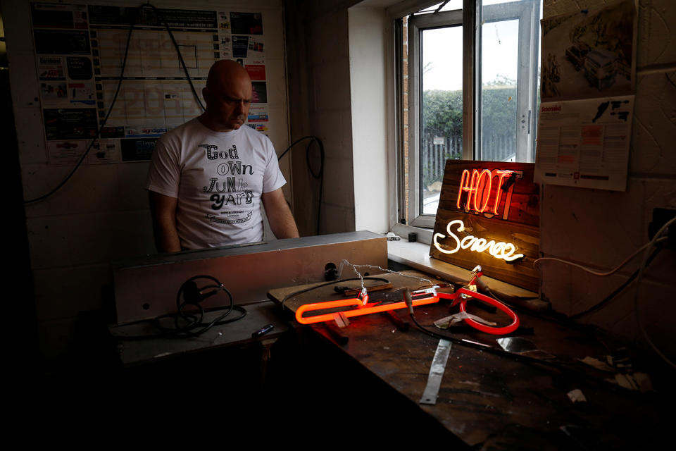 <p>Neon Bender, Nick Ellwood uses a pump to vacuum out neon tubes to remove impurities in God’s Own Junkyard workshop in Rainham, east London, Britain, May 17, 2017. (Photo: Russell Boyce/Reuters) </p>